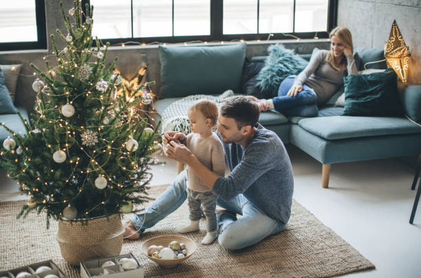Father and daughter decorate a christmas tree | Simple Flooring Solutions