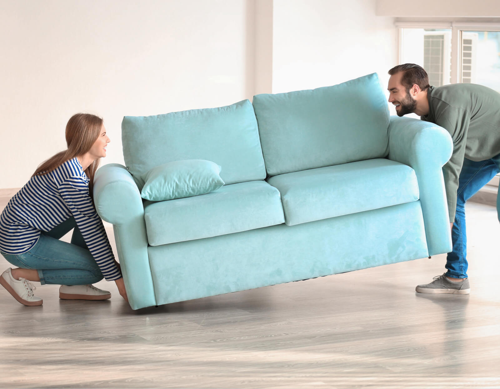 Couple moving sofa | Simple Flooring Solutions