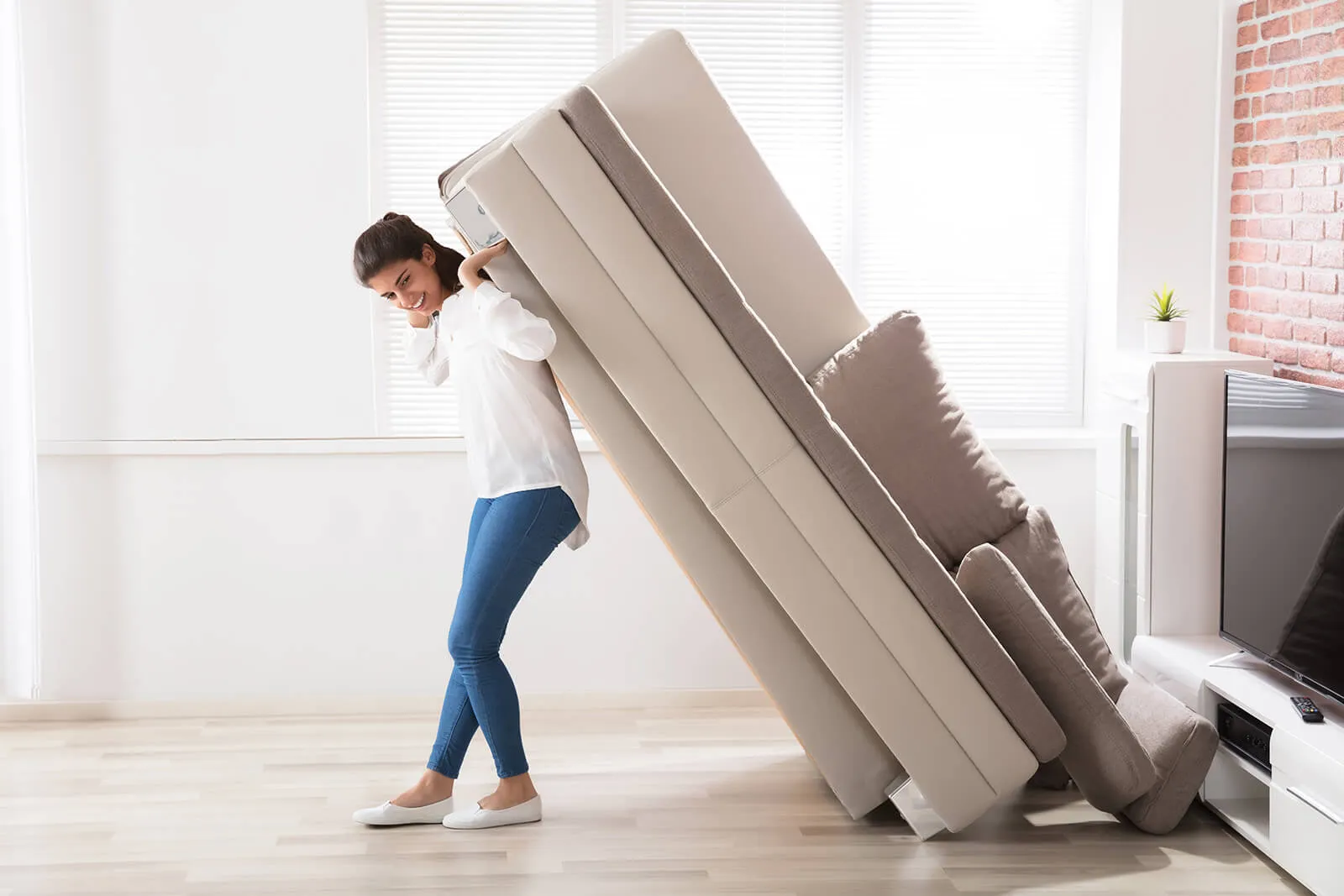 Lady moving sofa | Simple Flooring Solutions